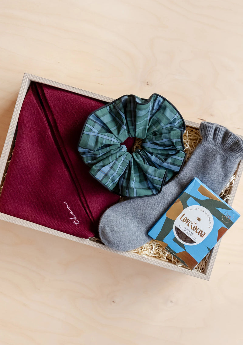Gift box with plaid scarf, socks and greeting card