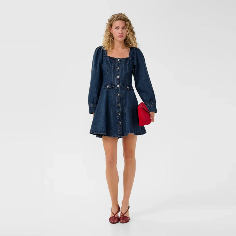 Woman wearing a denim dress.